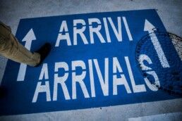 new arrivals sign on the floor of an airport