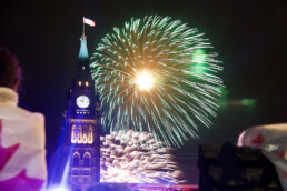 Fireworks burst in the sky behind Canada's Peace Tower.