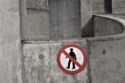 no people sign on cement wall