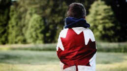 Person wrapped in Canadian flag