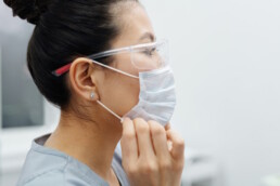 Healthcare worker wearing mask and safety glasses