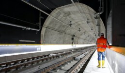 Worker standing in train tunnel